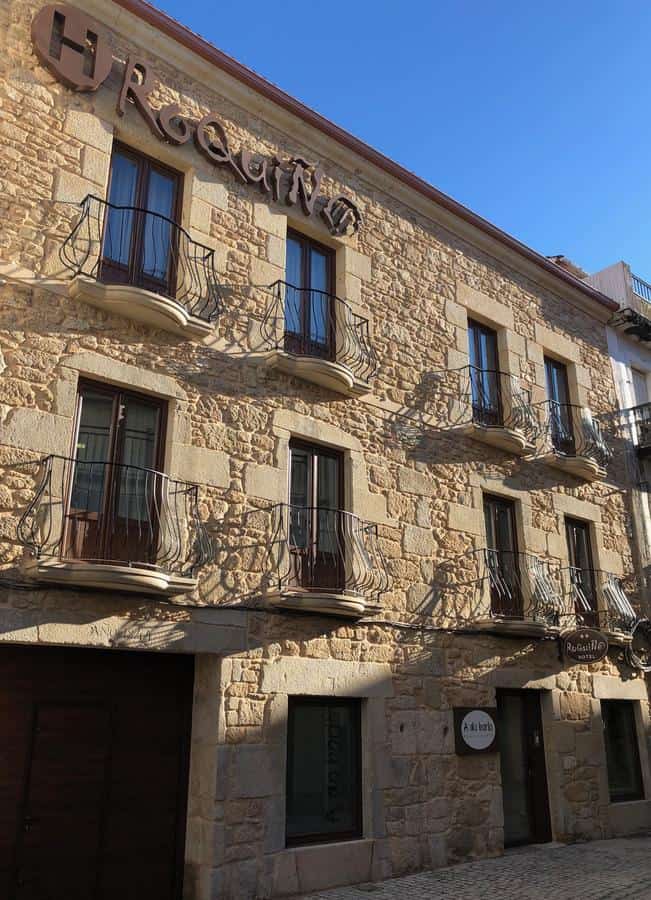 Historic Torre do Río building with stone facade and small balconies.