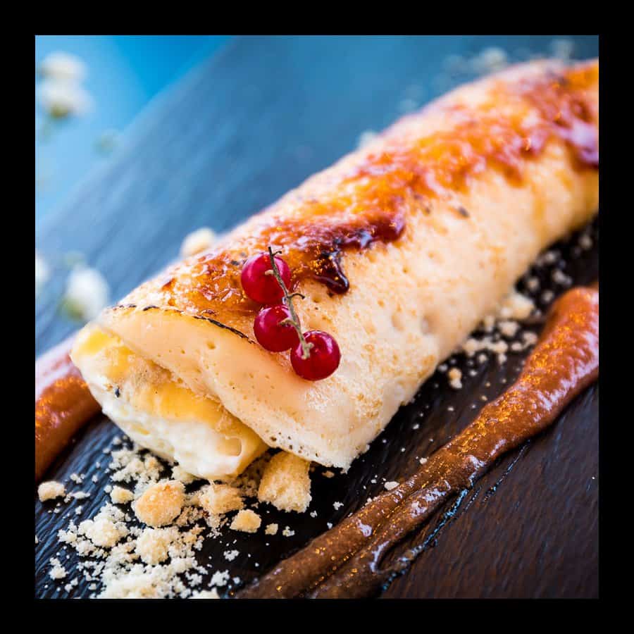 Delicious crepe filled with cheese, topped with red currants and powdered sugar.