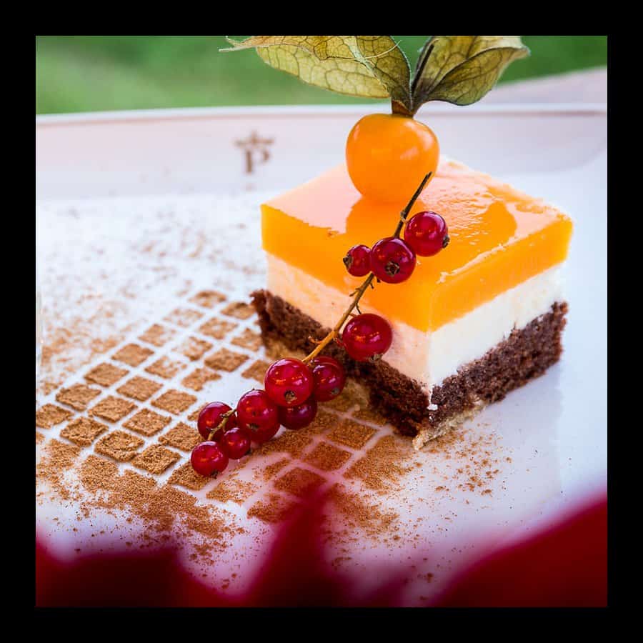 Elegant layered dessert with fruit garnish at Parador de Tui.