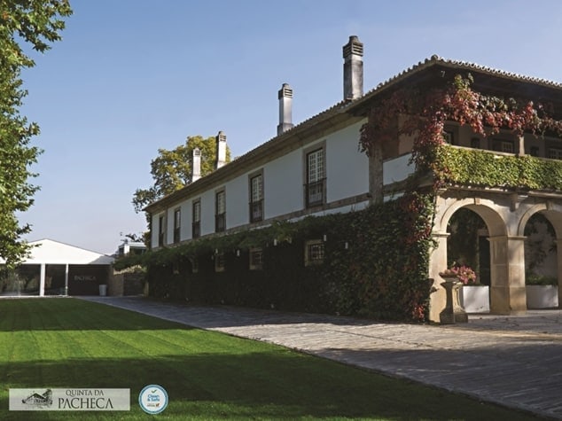 Scenic view of Quinta da Pacheca estate with lush gardens and historic building.